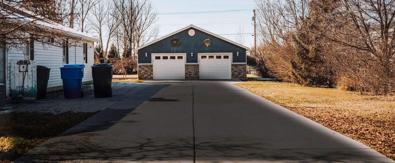 Driveway with dark algae and grime staining before pressure washing